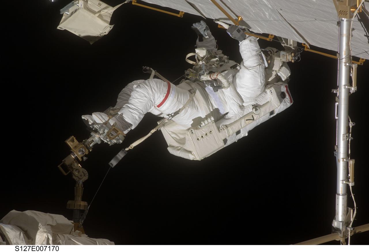 S127-E-007170 (20 July 2009) --- This is one of a series of digital still images showing astronaut Dave Wolf performing his second spacewalk and the Endeavour’s second also of the scheduled five overall in a little over a week’s time to continue work on the International Space Station.  Astronauts Wolf and Tom Marshburn (out of frame), both mission specialists,  successfully transferred a spare KU-band antenna to long-term storage on the space station, along with a backup coolant system pump module and a spare drive motor for the station's robot arm transporter. Installation of a television camera on the Japanese Exposed Facility experiment platform was deferred to a later spacewalk.