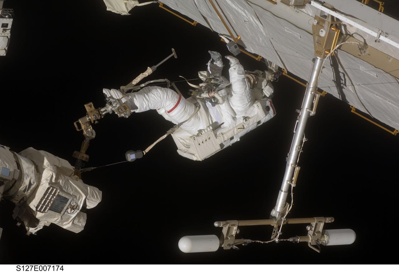 S127-E-007174 (20 July 2009) --- This is one of a series of digital still images showing astronaut Dave Wolf performing his second spacewalk and the Endeavour’s second also of the scheduled five overall in a little over a week’s time to continue work on the International Space Station.  Astronauts Wolf and Tom Marshburn (out of frame), both mission specialists,  successfully transferred a spare KU-band antenna to long-term storage on the space station, along with a backup coolant system pump module and a spare drive motor for the station's robot arm transporter. Installation of a television camera on the Japanese Exposed Facility experiment platform was deferred to a later spacewalk.