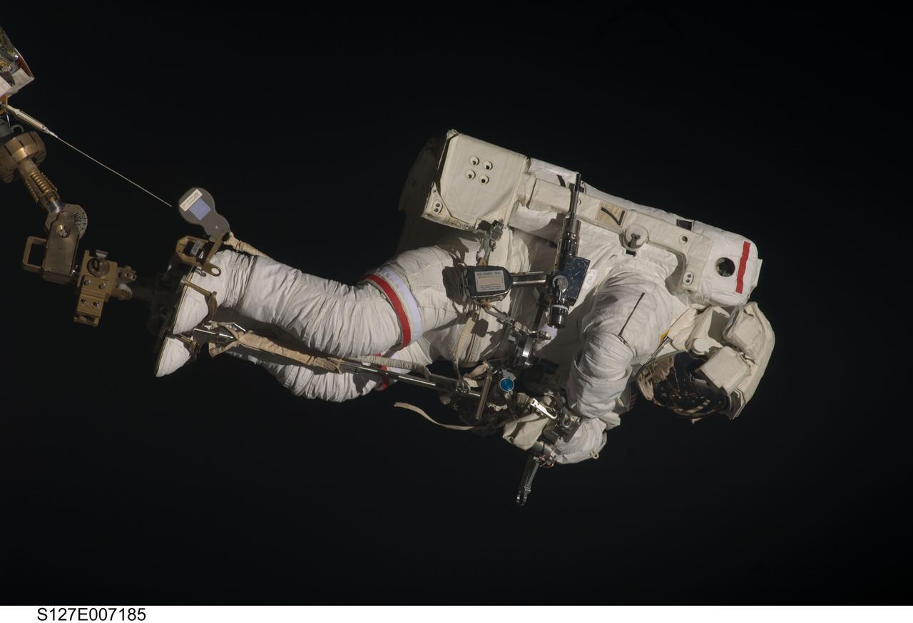 S127-E-007185 (20 July 2009) --- This is one of a series of digital still images showing astronaut Dave Wolf performing his second spacewalk and the Endeavour’s second also of the scheduled five overall in a little over a week’s time to continue work on the International Space Station.  Astronauts Wolf and Tom Marshburn (out of frame), both STS-127 mission specialists, successfully transferred a spare KU-band antenna to long-term storage on the space station, along with a backup coolant system pump module and a spare drive motor for the station's robot arm transporter. Installation of a television camera on the Japanese Exposed Facility experiment platform was deferred to a later spacewalk.