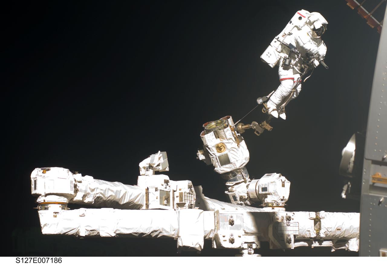 S127-E-007186 (20 July 2009) --- This is one of a series of digital still images showing astronaut Dave Wolf performing his second spacewalk and the Endeavour’s second also of the scheduled five overall in a little over a week’s time to continue work on the International Space Station.  Astronauts Wolf and Tom Marshburn (out of frame), both mission specialists,  successfully transferred a spare KU-band antenna to long-term storage on the space station, along with a backup coolant system pump module and a spare drive motor for the station's robot arm transporter. Installation of a television camera on the Japanese Exposed Facility experiment platform was deferred to a later spacewalk.