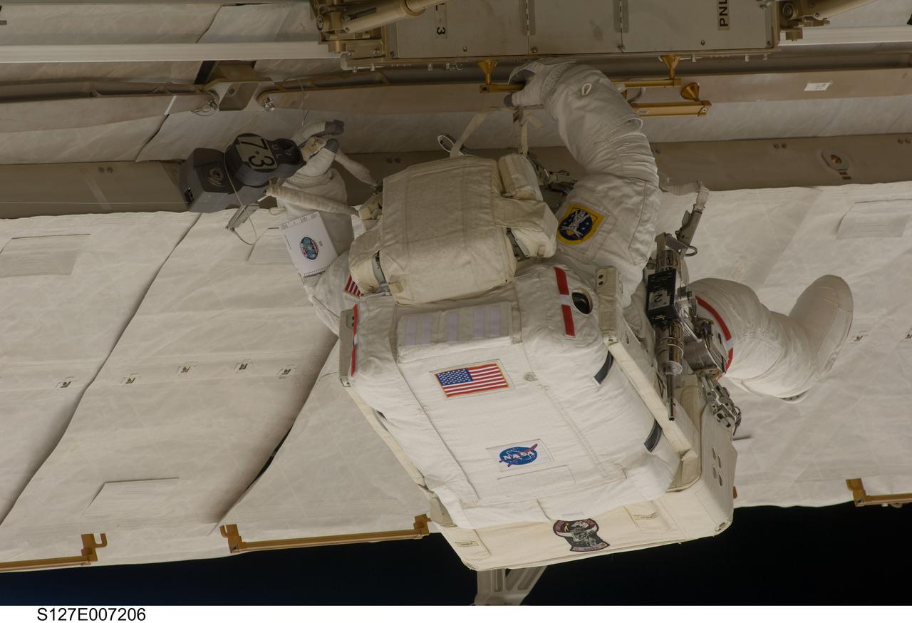 S127-E-007206 (20 July 2009) --- This is one of a series of digital still images showing astronaut Tom Marshburn performing his first spacewalk and the Endeavour crew’s second of the scheduled five overall in a little more than a week to continue work on the International Space Station. Astronauts Marshburn and Dave Wolf (out of frame), both mission specialists, successfully transferred a spare KU-band antenna to long-term storage on the space station, along with a backup coolant system pump module and a spare drive motor for the station's robot arm transporter. Installation of a television camera on the Japanese Exposed Facility experiment platform was deferred to a later spacewalk.