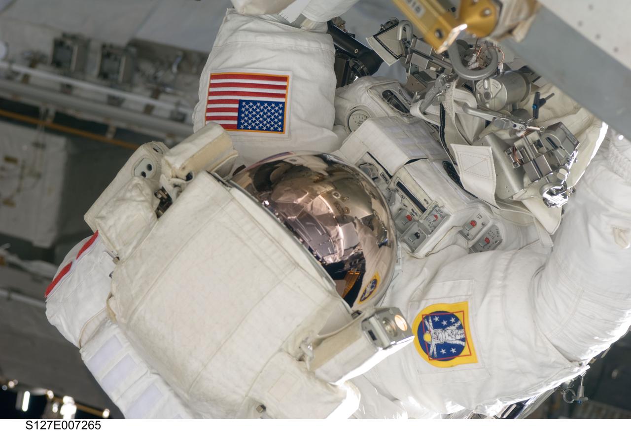 S127-E-007265 (20 July 2009) --- This is one of a series of digital still images showing astronaut Tom Marshburn performing his first spacewalk and the Endeavour crew’s second of the scheduled five overall in a little more than a week to continue work on the International Space Station. Astronauts Marshburn and Dave Wolf (out of frame), both mission specialists, successfully transferred a spare KU-band antenna to long-term storage on the space station, along with a backup coolant system pump module and a spare drive motor for the station's robot arm transporter. Installation of a television camera on the Japanese Exposed Facility experiment platform was deferred to a later spacewalk.