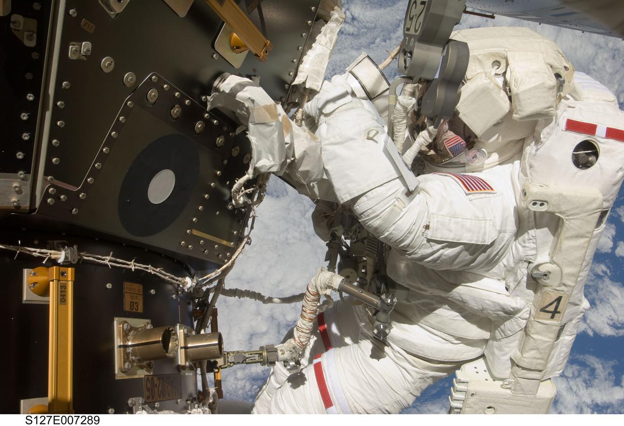 S127-E-007289 (20 July 2009) --- This is one of a series of digital still images showing astronaut Tom Marshburn performing his first spacewalk and the Endeavour crew’s second of the scheduled five overall in a little more than a week to continue work on the International Space Station. Astronauts Marshburn and Dave Wolf (out of frame), both mission specialists, successfully transferred a spare KU-band antenna to long-term storage on the space station, along with a backup coolant system pump module and a spare drive motor for the station's robot arm transporter. Installation of a television camera on the Japanese Exposed Facility experiment platform was deferred to a later spacewalk.