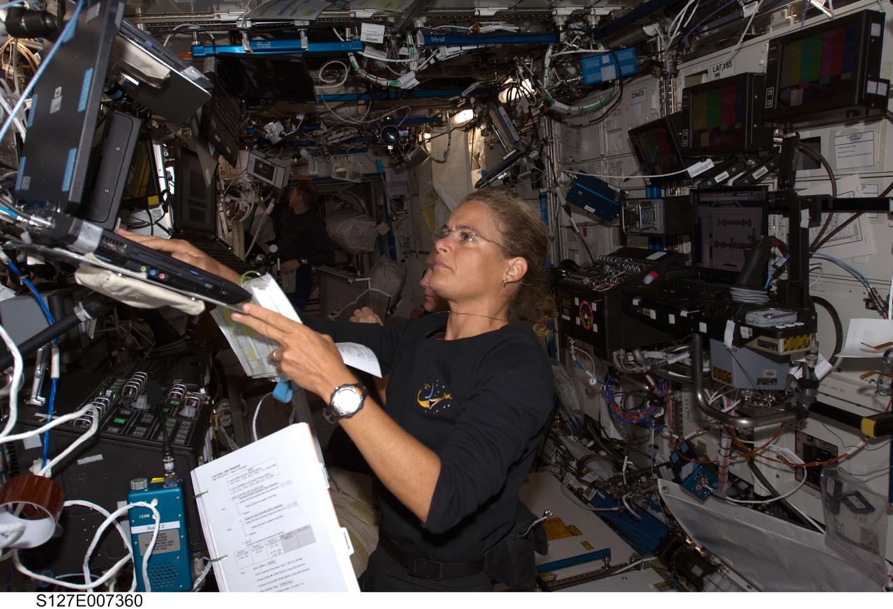 S127-E-007360 (20 July 2009) --- During the second STS-127 spacewalk, Canadian Space Agency astronaut Julie Payette, mission specialist, provides support for her crewmates inside the International Space Station's U.S. lab (Destiny). Payette was joined in the lab by astronaut Doug Hurley, STS-127 pilot (almost totally out of view in this frame).