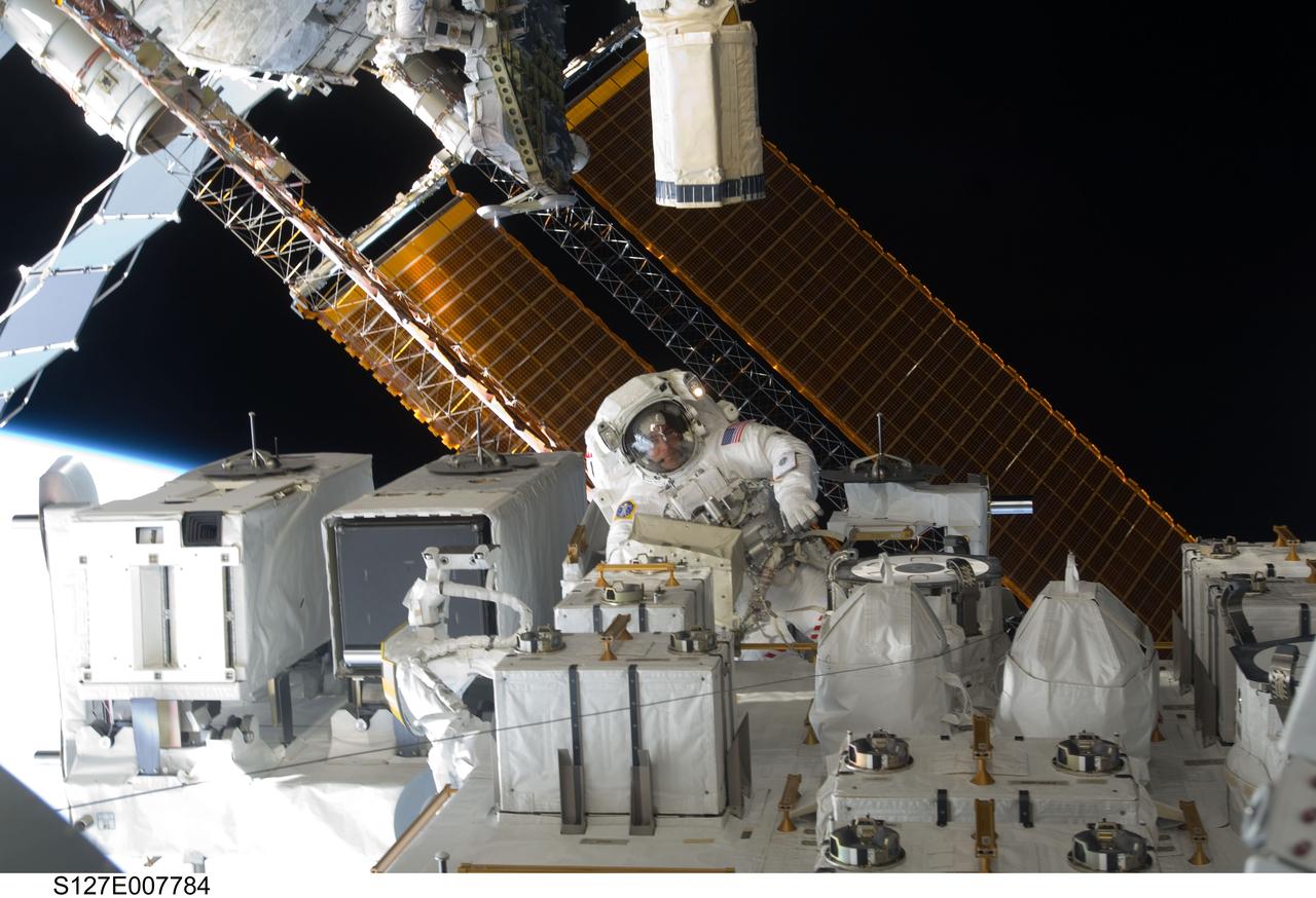 S127-E-007984 (22 July 2009) --- Astronaut Christopher Cassidy, STS-127 mission specialist, is pictured in the center of this wide shot photographed during Endeavour's third space walk of a scheduled five overall for this flight. Cassidy is near the Japanese Experiment Module - Exposed Facility (JEF). This was Cassidy's first of a scheduled three sessions for him. Astronaut Dave Wolf, Cassidy's EVA colleague, is out of frame.
