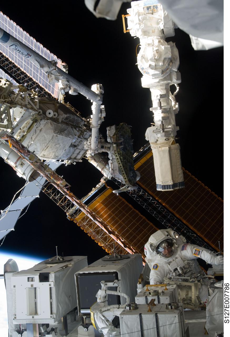 S127-E-007786 (22 July 2009) --- Astronaut Christopher Cassidy, STS-127 mission specialist, is pictured in the lower right corner of this wide shot photographed during Endeavour's third space walk of a scheduled five overall for this flight. Cassidy is near the Japanese Experiment Module - Exposed Facility (JEF) This was Cassidy's first of a scheduled three sessions for him. Astronaut Dave Wolf, Cassidy's EVA colleague, is out of frame.