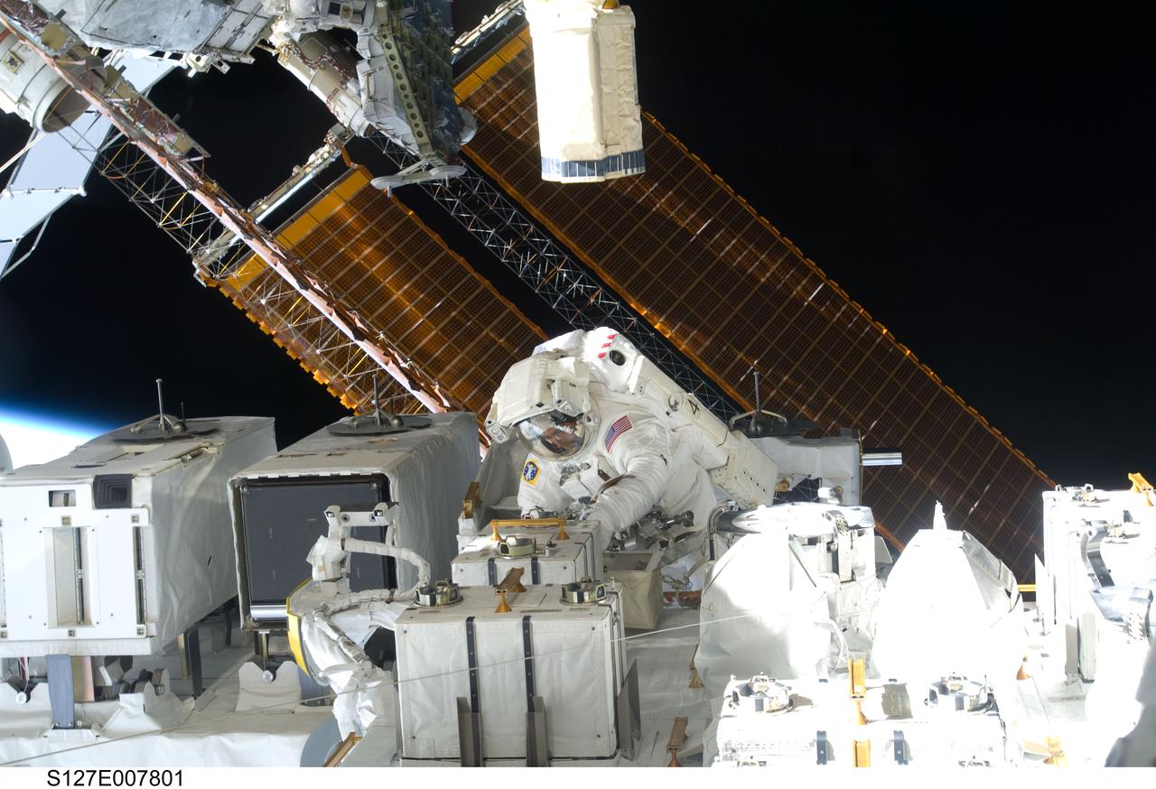 S127-E-007801 (22 July 2009) --- Astronaut Christopher Cassidy, STS-127 mission specialist, is pictured in the center of this wide shot photographed during Endeavour's third space walk of a scheduled five overall for this flight. Cassidy is near The Japanese Experiment Module - Exposed Facility (JEF.) This was Cassidy's first of a scheduled three sessions for him. Astronaut Dave Wolf, Cassidy's EVA colleague, is out of frame.