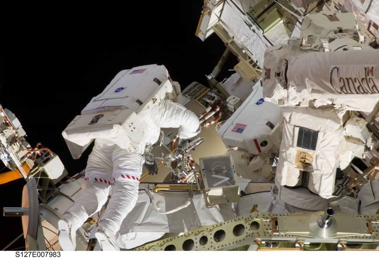 S127-E-007983 (22 July 2009) --- Astronaut Christopher Cassidy, STS-127 mission specialist, participates in Endeavour's third space walk of a scheduled five overall for this flight. This was Cassidy's first of a scheduled three sessions for him. Astronaut Dave Wolf, Cassidy's EVA colleague, partially visible at right.
