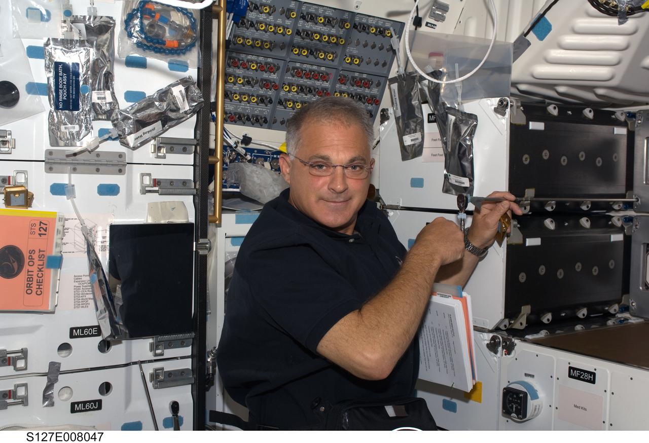 S127-E-008047 (23 July 2009) --- Astronaut Dave Wolf, STS-127 mission specialist, on Endeavour's middeck during flight day nine.