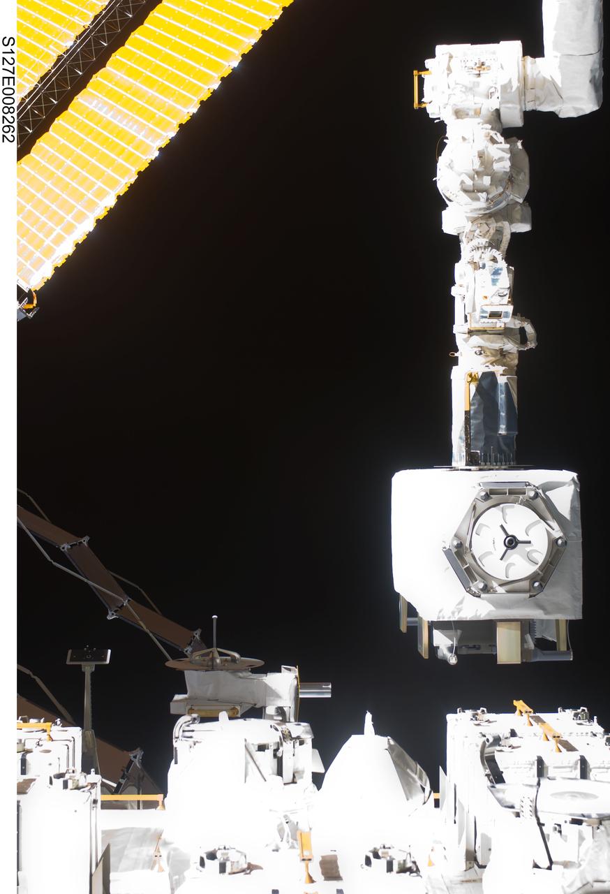 S127-E-008262 (23 July 2009) --- This is a July 23 (flight day 9) view of the robotic arm for the Japanese Experiment Module or Kibo as it assists in the deployment of the JAXA Space Environment Data Acquisition Attached Payload (SEDA-AP) onto the Japanese Exposed Facility Unit (EFU).
