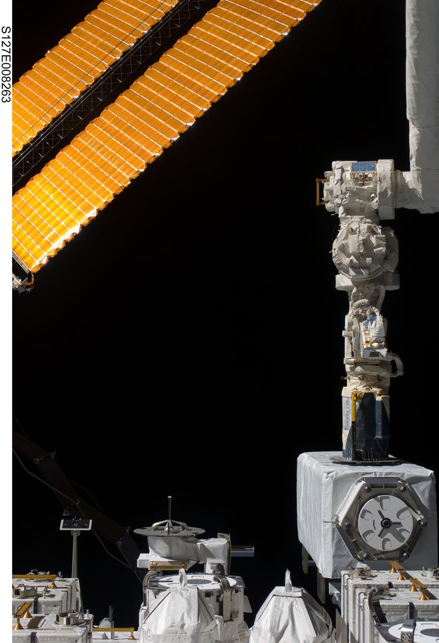 S127-E-008263 (23 July 2009) --- This is a July 23 (flight day 9) view of the robotic arm for the Japanese Experiment Module or Kibo as it assists in the deployment of the JAXA Space Environment Data Acquisition Attached Payload (SEDA-AP) onto the Japanese Exposed Facility Unit (EFU).
