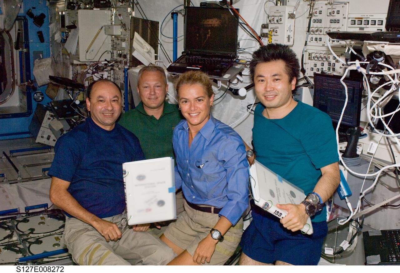 S127-E-008272 (23 July 2009) --- From left, astronauts Mark Polansky, STS-127 commander; and Doug Hurley, pilot; with Canadian Space Agency astronaut Julie Payette and Japanese Aerospace Exploration Agency astronaut Koichi Wakata, both mission specialists, assemble in the Japanese Experiment Module or Kibo during flight day 9 activities on the International Space Station.