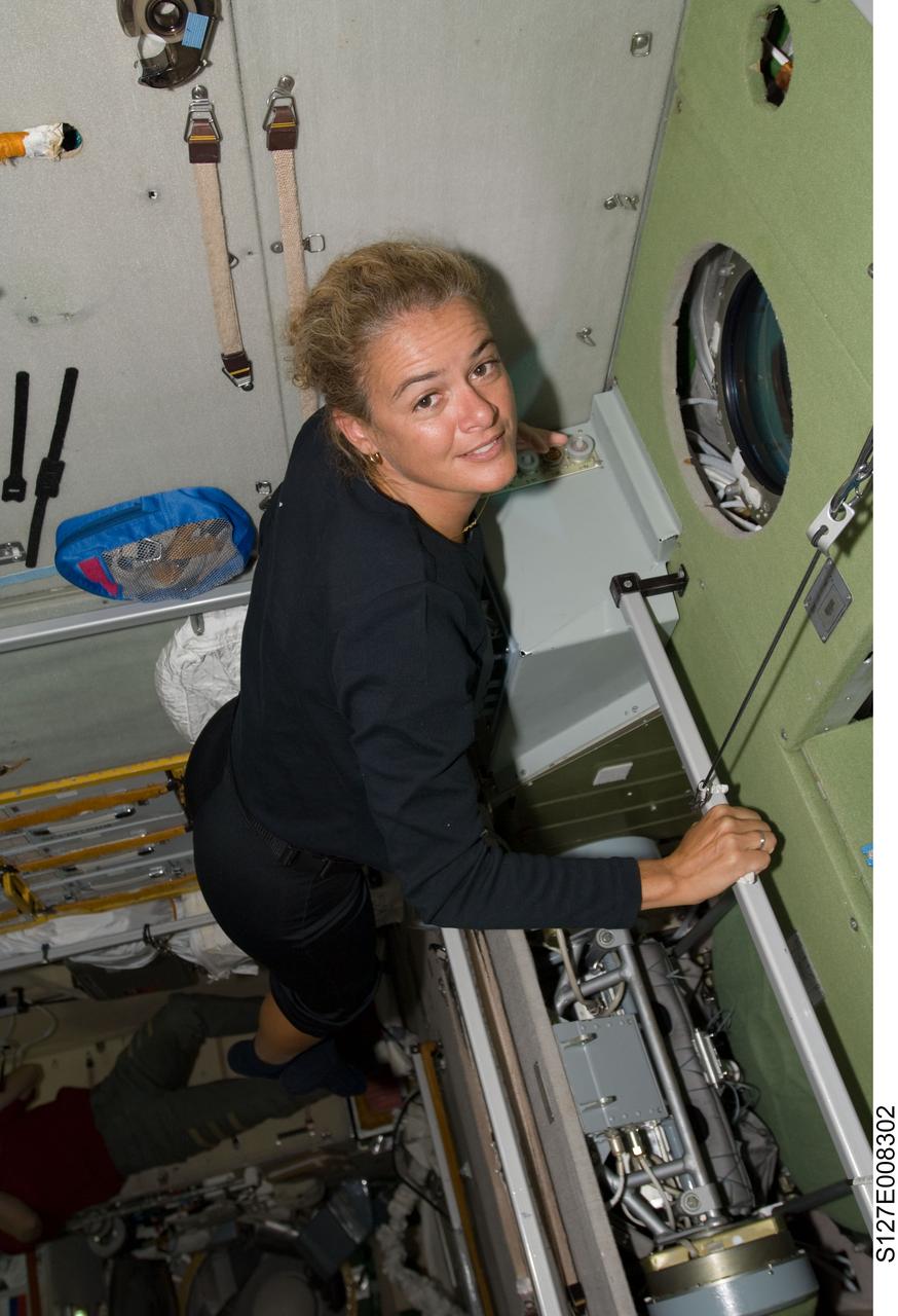 S127-E-008302 (23 July 2009) --- Canadian Space Agency astronaut Julie Payette, STS-127 mission specialist, is pictured as she looks out a window in the Zvezda service module on flight day 9.