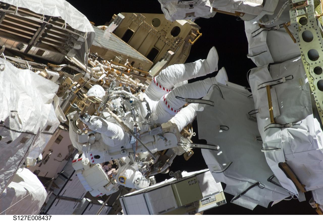 S127-E-008437 (24 July 2009) --- Astronauts Tom Marshburn (partially obscured) and Christopher Cassidy (center frame), mission specialists for STS-127, makes sense out of all the hardware facing them as they share duties on the fourth spacewalk of Endeavour's current mission and its crew's joint activities with the space station. Eleven astronauts and cosmonauts remained inside the International Space Station and the shuttle to which it was docked, while the two continued work on the orbital outpost. The two will team up for the mission's final spacewalk on July 27.