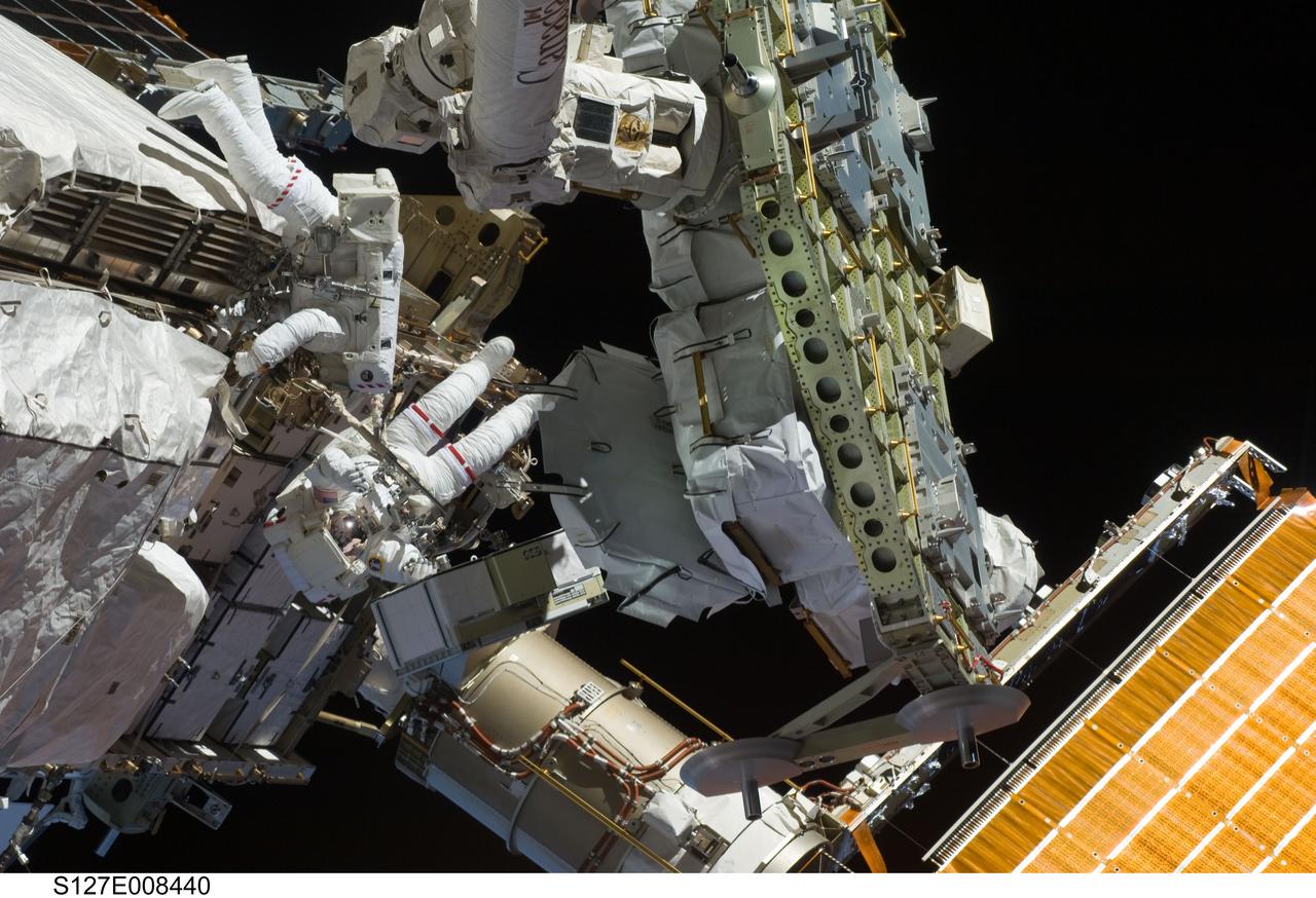 S127-E-008440 (24 July 2009) --- Astronauts Tom Marshburn (upper left) and Christopher Cassidy (seen just below Marshburn), mission specialists for STS-127, share duties on the fourth spacewalk of Endeavour's current mission and its crew's joint activities with the space station. Eleven astronauts and cosmonauts remained inside the International Space Station and the shuttle to which it was docked, while the two continued work on the orbital outpost. The two will team up for the mission's final spacewalk on July 26.