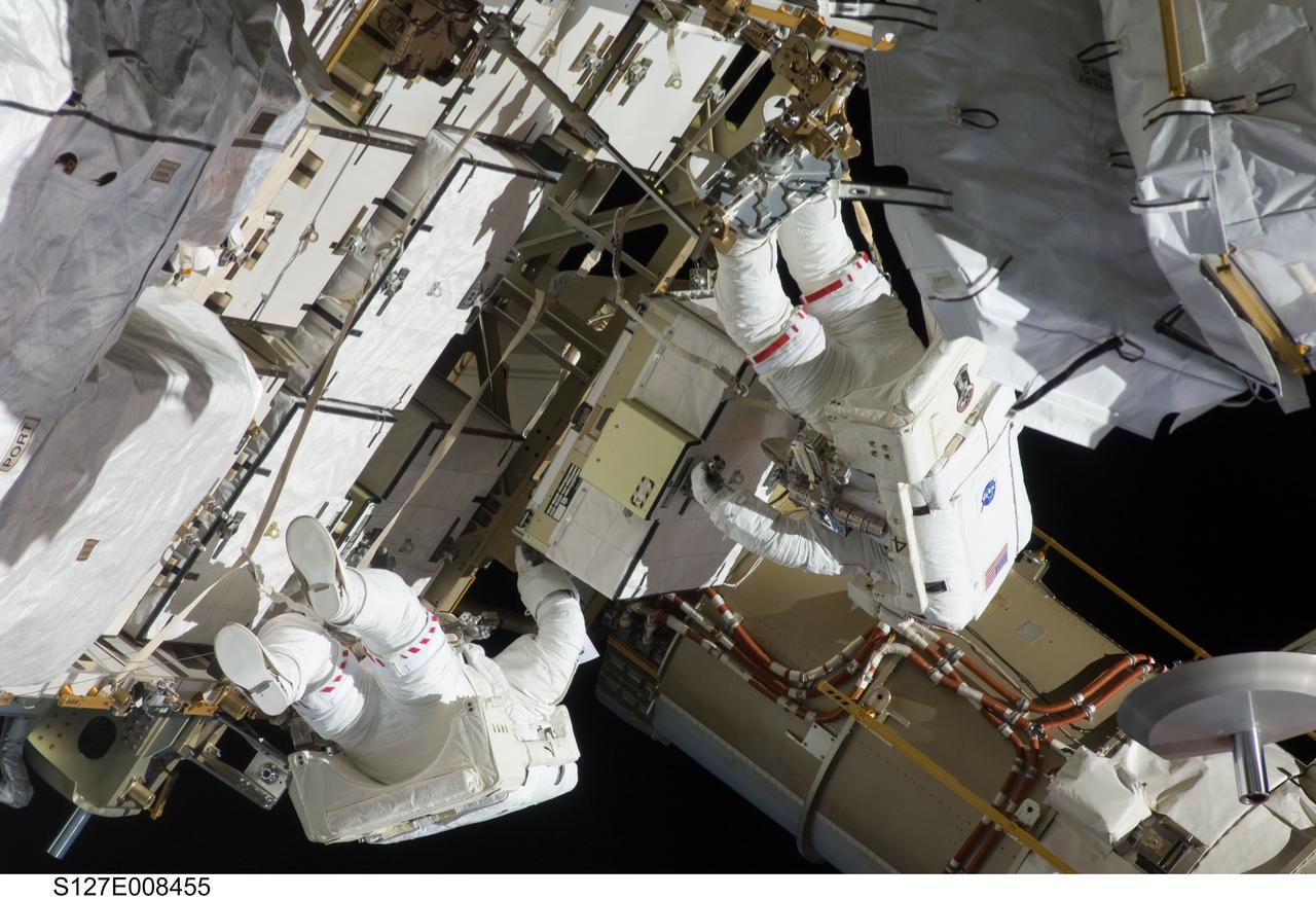 S127-E-008455 (24 July 2009) --- Astronauts Christopher Cassidy (left) and Tom Marshburn, mission specialists for STS-127, share duties on the fourth spacewalk of Endeavour's current mission and its crew's joint activities with the space station. Eleven astronauts and cosmonauts remained inside the International Space Station and the shuttle to which it was docked, while the two continued work on the orbital outpost. The two will team up for the mission's final spacewalk on July 27.