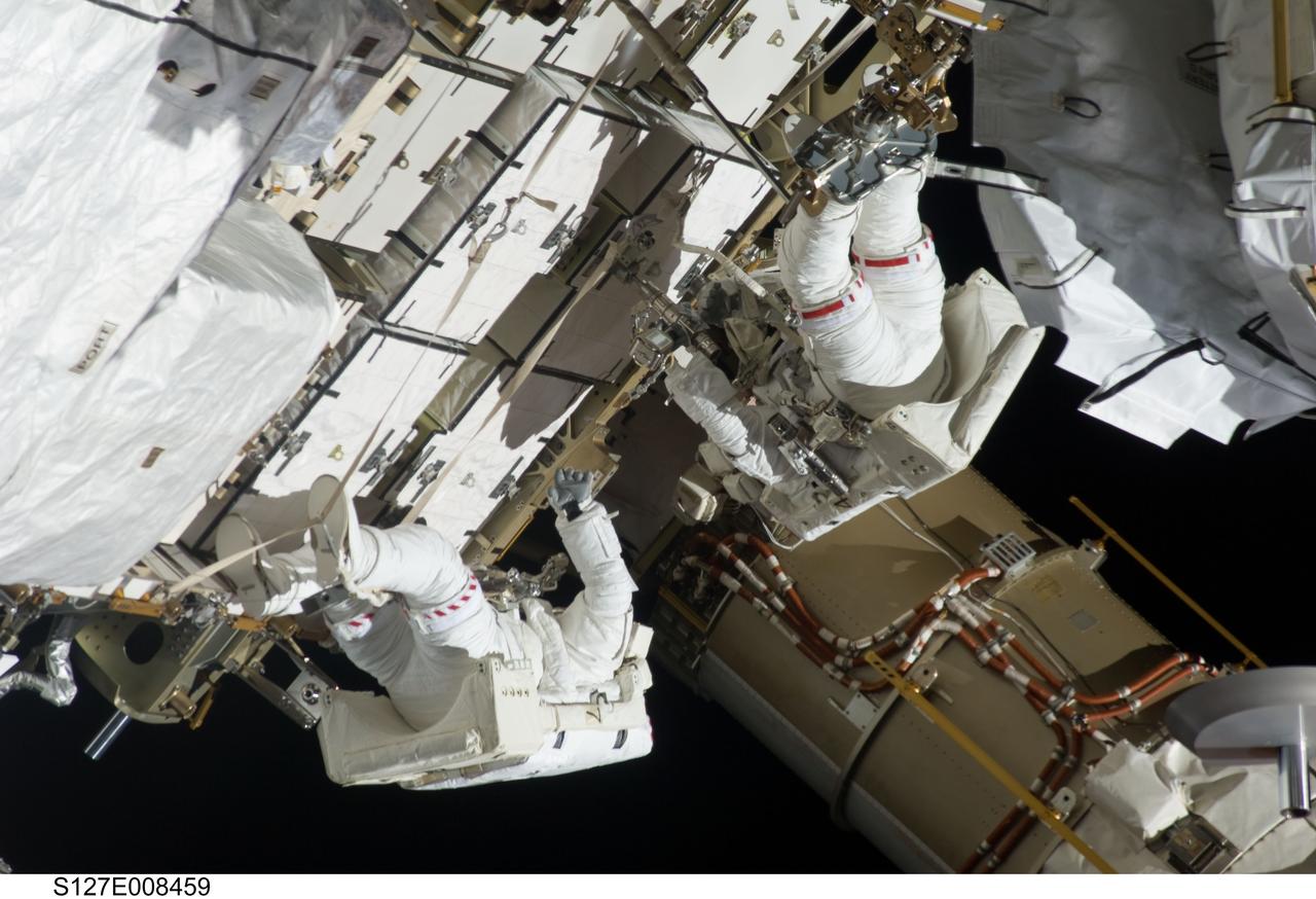 S127-E-008459 (24 July 2009) --- Astronauts Tom Marshburn (right) and Christopher Cassidy, mission specialists for STS-127, share duties on the fourth spacewalk of Endeavour's current mission and its crew's joint activities with the space station. Eleven astronauts and cosmonauts remained inside the International Space Station and the shuttle to which it was docked, while the two continued work on the orbital outpost.