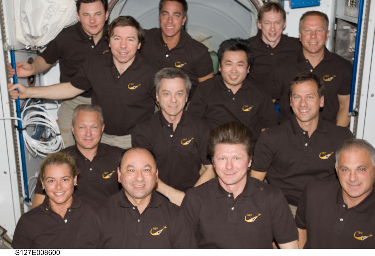 S127-E-008600 (25 July 2009) --- These 13 space fliers are spending more than a week together onboard the International Space Station, marking a population record on the orbital outpost.  On front row, left  to right, are Canadian Space Agency astronaut Julie Payette, astronaut Mark Polansky, Russian Federal Space Agency cosmonaut Gennady Padalka and astronaut Dave Wolf.  On second row, are astronaut Doug Hurley, Canadian Space Agency astronaut Robert Thirsk, Japanese Aerospace Exploration Agency astronaut Koichi Wakata and astronaut Tom Marshburn. On the back row are Russian Federal Space Agency cosmonaut Roman Romanenko, astronauts Mike Barratt and Christopher Cassidy, along with European Space Agency astronaut Frank DeWinne and astronaut Tim Kopra.