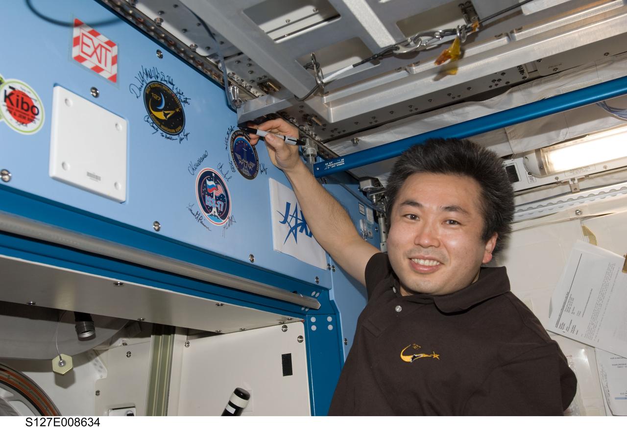 S127-E-008624 (25 July 2009) --- Flight day 11 activities for the joint shuttle-station crews included the traditional autographing of the station. Japanese Aerospace Exploration Agency Astronaut Koichi Wakata, STS-127 mission specialist, has the pen in this frame.