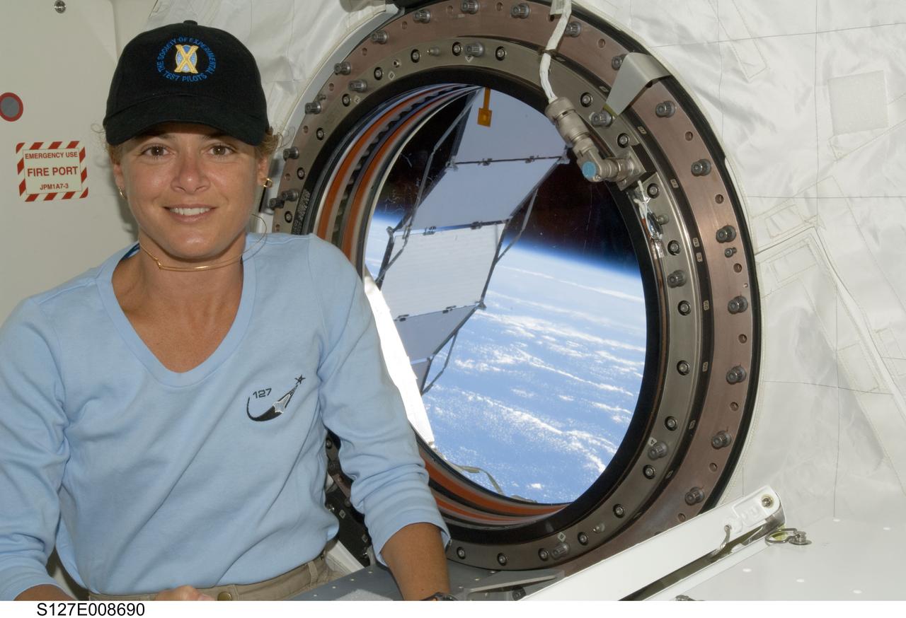 S127-E-008690 (25 July 2009) --- Canadian Space Agency astronaut Julie Payette, STS-127 mission specialist, is pictured near a window in the Kibo laboratory of the International Space Station while Space Shuttle Endeavour remains docked with the station.