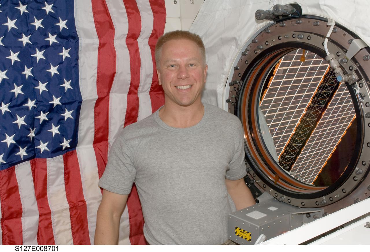 S127-E-008701 (25 July 2009) --- Astronaut Tim Kopra, Expedition 20 flight engineer, is pictured near a window in the Kibo laboratory of the International Space Station while Space Shuttle Endeavour (STS-127) remains docked with the station.