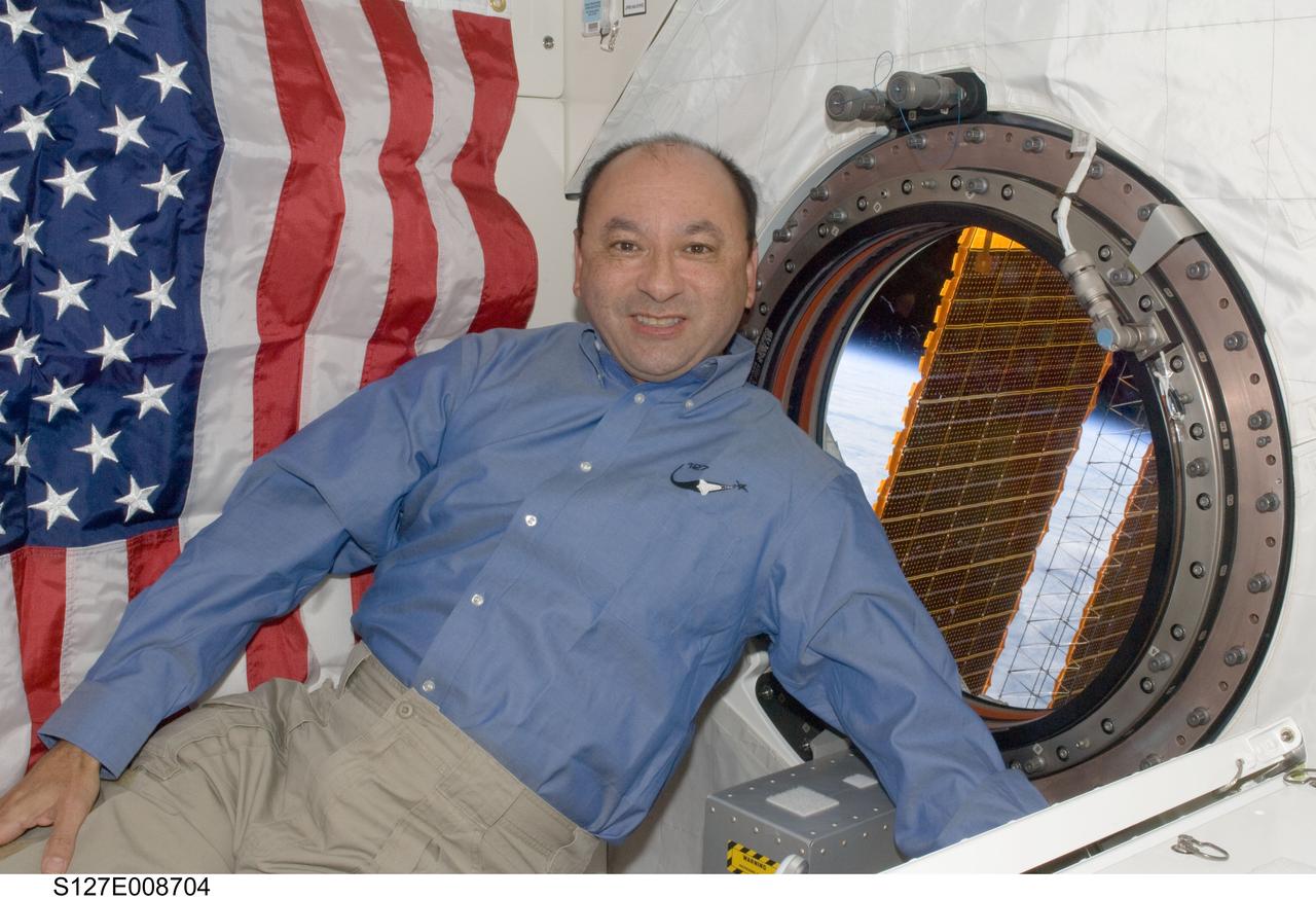 S127-E-008704 (25 July 2009) --- Astronaut Mark Polansky, STS-127 commander, is pictured near a window in the Kibo laboratory of the International Space Station while Space Shuttle Endeavour remains docked with the station.
