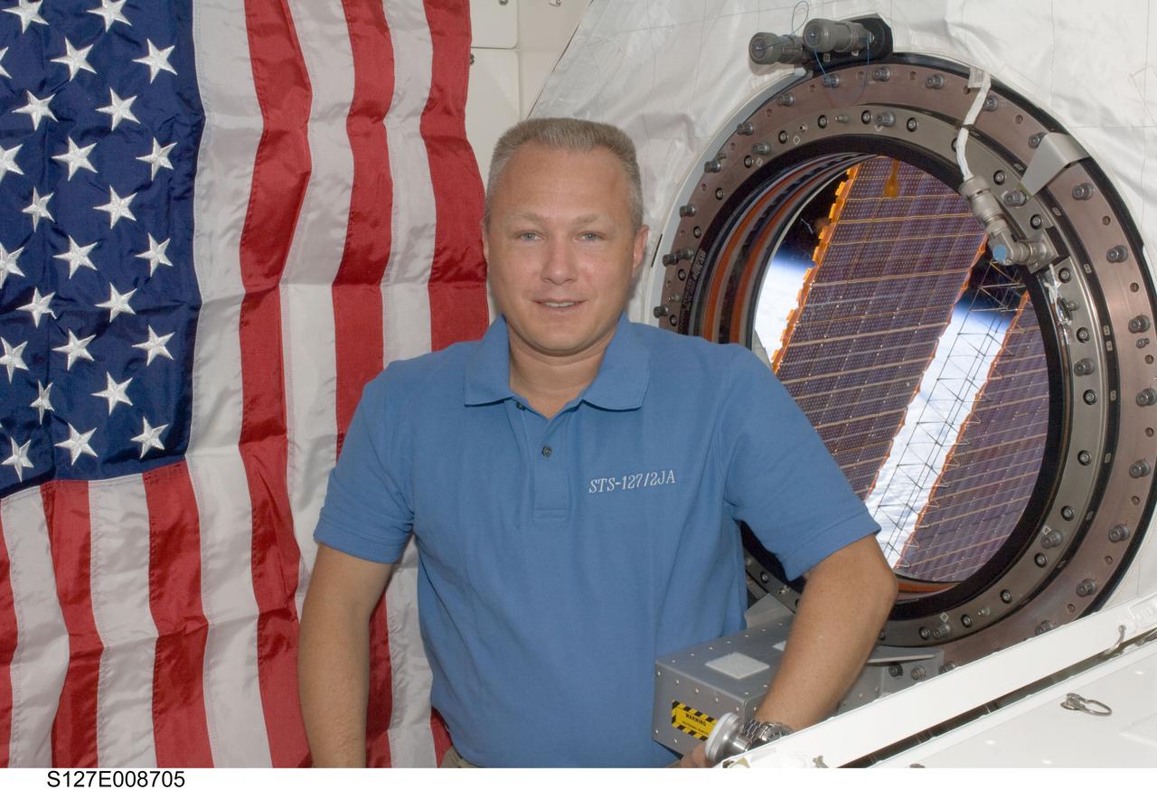 S127-E-008705 (25 July 2009) --- Astronaut Doug Hurley, STS-127 pilot, is pictured near a window in the Kibo laboratory of the International Space Station while Space Shuttle Endeavour remains docked with the station.