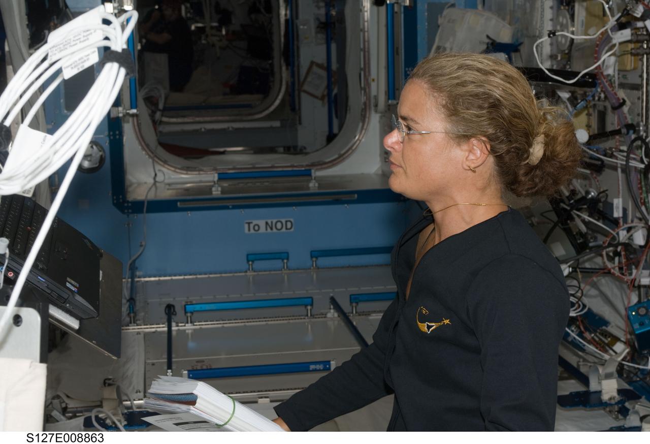 S127-E-008863 (26  July 2009) --- Canadian Space Agency astronaut Julie Payette, STS-127 mission specialist, views a computer monitor while working in the Destiny laboratory of the International Space Station while Space Shuttle Endeavour remains docked with the station.
