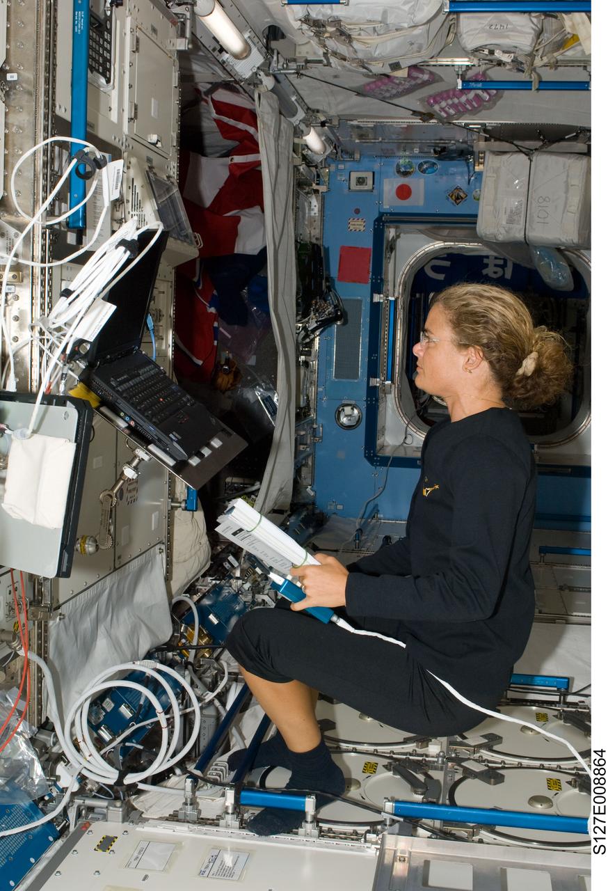 S127-E-008864 (26  July 2009) --- Canadian Space Agency astronaut Julie Payette, STS-127 mission specialist, views a computer monitor while working in the Destiny laboratory of the International Space Station while Space Shuttle Endeavour remains docked with the station.