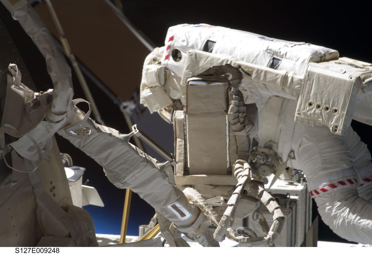 S127-E-009248 (27 July 2009) --- Astronaut Christopher Cassidy, STS-127 mission specialist, participates in the mission's fifth and final session of extravehicular activity (EVA) as construction and maintenance continue on the International Space Station. During the four-hour, 54-minute spacewalk, Cassidy and astronaut Tom Marshburn (out of frame), mission specialist, secured multi-layer insulation around the Special Purpose Dexterous Manipulator known as Dextre, split out power channels for two space station Control Moment Gyroscopes, installed video cameras on the front and back of the new Japanese Exposed Facility and performed a number of “get ahead” tasks, including tying down some cables and installing handrails and a portable foot restraint to aid future spacewalkers.