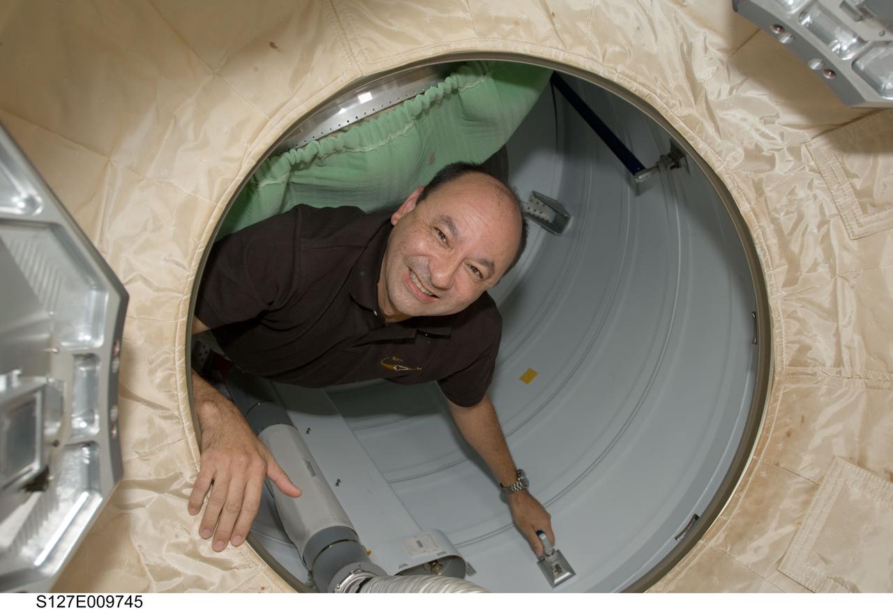 S127-E-009745 (28 July 2009) --- NASA astronaut Mark Polansky, STS-127 commander, is pictured in the hatch between Space Shuttle Endeavour and the International Space Station as the STS-127 crew members prepare for the undocking of the two spacecraft.