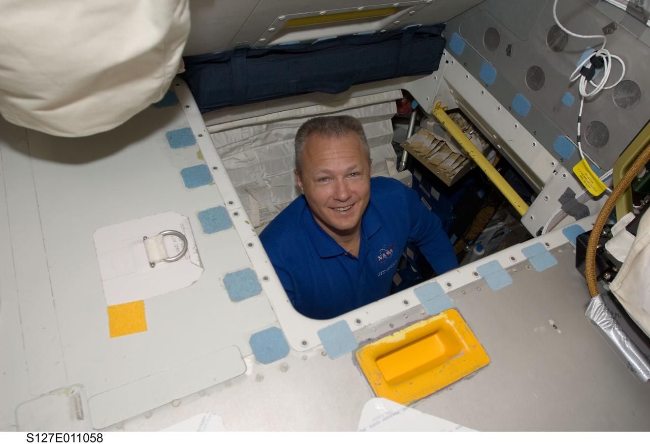 S127-E-011058 (28 July 2009) --- Astronaut Doug Hurley, STS-127 pilot, smiles for the camera while in the hatch which connects the flight deck and middeck of Space Shuttle Endeavour during flight day 14 activities.