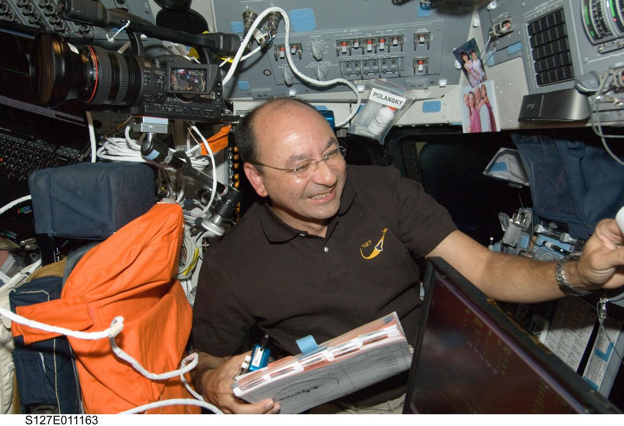 S127-E-011163 (28 July 2009) --- Astronaut Mark Polansky, STS-127 commander, works on the flight deck of Space Shuttle Endeavour during flight day 14 activities.