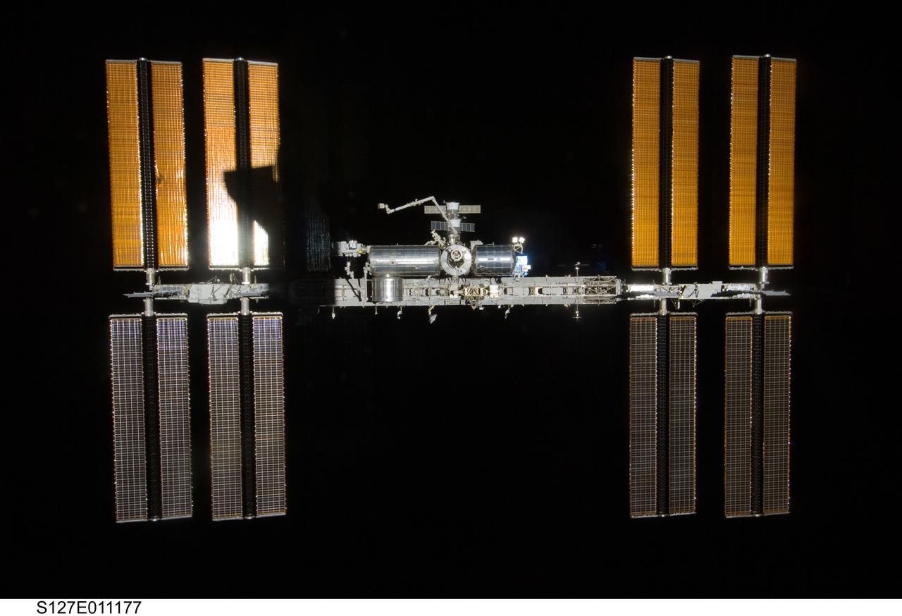 S127-E-011177 (28 July 2009) --- Backdropped by the blackness of space, the International Space Station is seen from Space Shuttle Endeavour as the two spacecraft begin their relative separation. Earlier the STS-127 and Expedition 20 crews concluded 11 days of cooperative work onboard the shuttle and station. Undocking of the two spacecraft occurred at 12:26 p.m. (CDT) on July 28, 2009. A partial shadow of Endeavour is visible on the solar array wing panels.