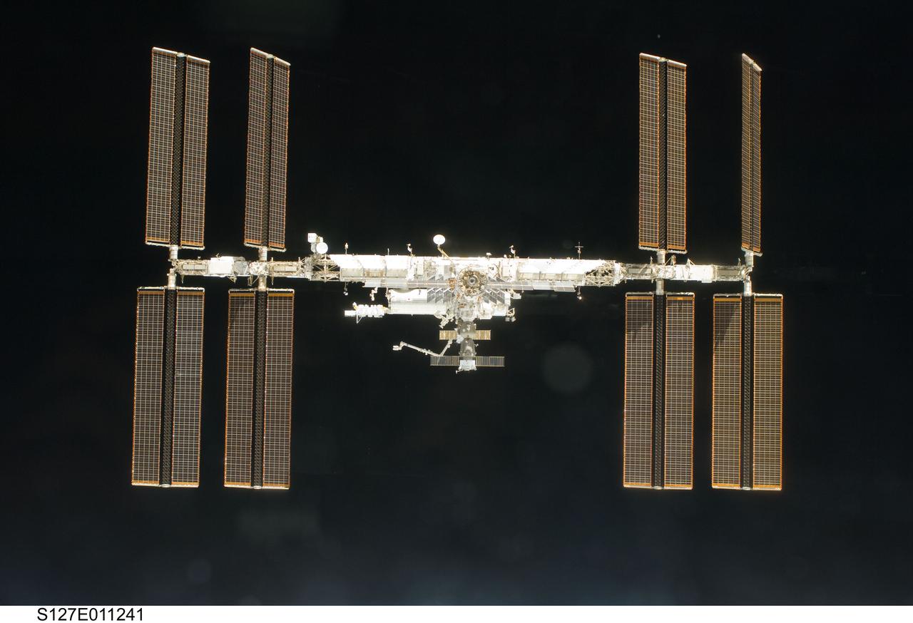 S127-E-011241 (28 July 2009) --- Backdropped by the blackness of space, the International Space Station is seen from Space Shuttle Endeavour as the two spacecraft begin their relative separation. Earlier the STS-127 and Expedition 20 crews concluded 11 days of cooperative work onboard the shuttle and station. Undocking of the two spacecraft occurred at 12:26 p.m. (CDT) on July 28, 2009. A partial shadow of Endeavour is visible on the solar array wing panels.