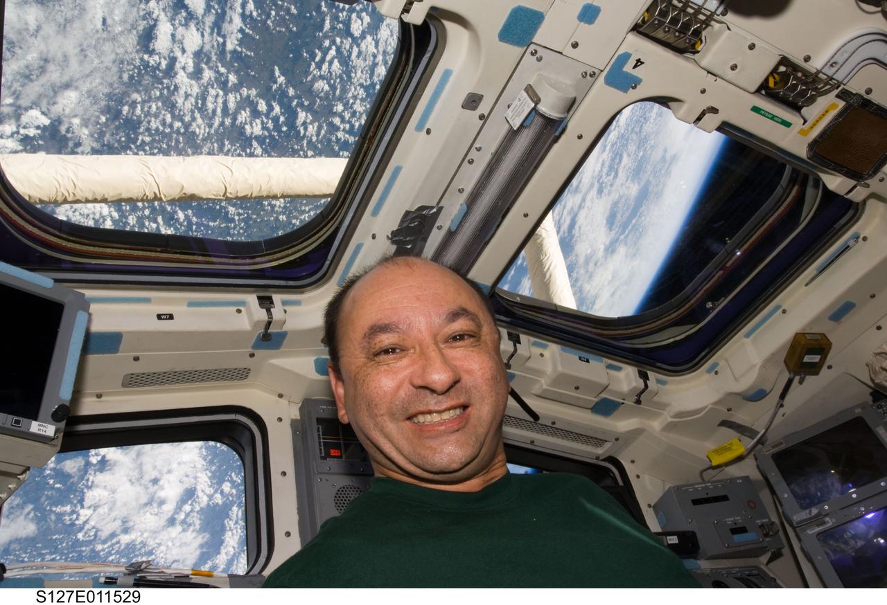 S127-E-011529 (29 July 2009) --- Astronaut Mark Polansky, STS-127 commander, is pictured near the control panels and windows on the aft flight deck of the Earth-orbiting Space Shuttle Endeavour.