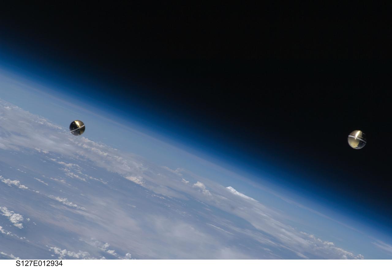 S127-E-012934 (30 July 2009) --- Backdropped by Earth’s horizon and the blackness of space, a Department of Defense pico-satellite known as Atmospheric Neutral Density Experiment 2 (ANDE-2) is photographed after its release from Space Shuttle Endeavour's payload bay by STS-127 crew members. ANDE-2 consists of two spherical micro-satellites which will measure the density and composition of the low-Earth orbit (LEO) atmosphere while being tracked from the ground. The data will be used to better predict the movement of objects in orbit.