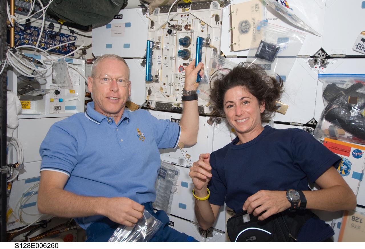 S128-E-006260 (29 Aug. 2009) --- Astronauts Patrick Forrester and Nicole Stott, both STS-128 mission specialists, are pictured on the middeck of Space Shuttle Discovery during flight day two activities.
