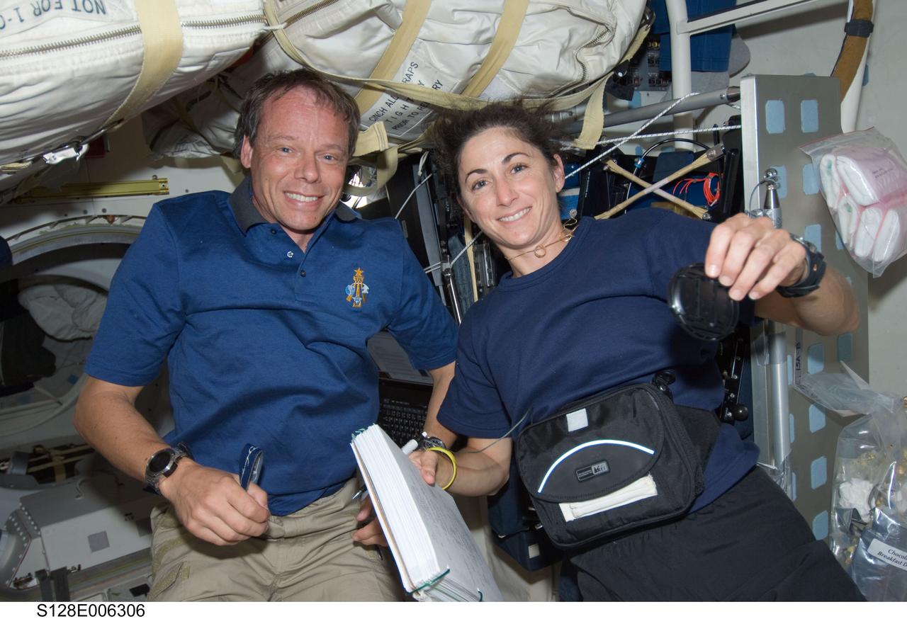 S128-E-006306 (29 Aug. 2009) --- European Space Agency astronaut Christer Fuglesang and NASA astronaut Nicole Stott, both STS-128 mission specialists, are pictured on Space Shuttle Discovery’s middeck during flight day two activities.