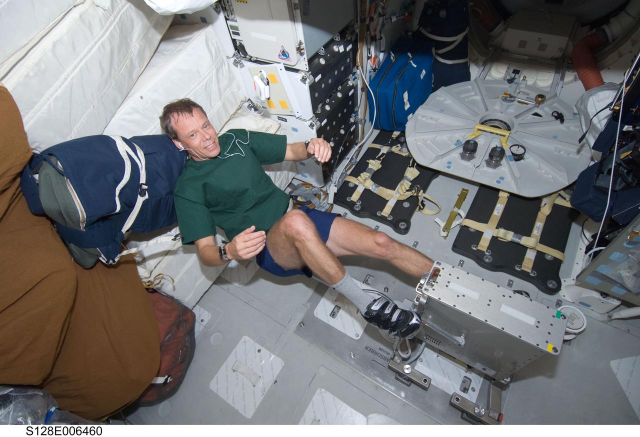 S128-E-006460 (29 Aug. 2009) --- European Space Agency astronaut Christer Fuglesang, STS-128 mission specialist, exercises on a bicycle ergometer on the middeck of the Earth-orbiting Space Shuttle Discovery.