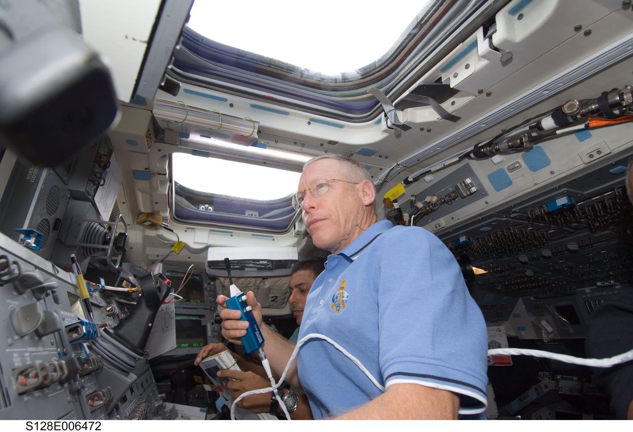 S128-E-006472 (29 Aug. 2009) --- Astronaut Patrick Forrester, STS-128 mission specialist, uses a communication system on the aft flight deck of the Earth-orbiting Space Shuttle Discovery during flight day two activities.