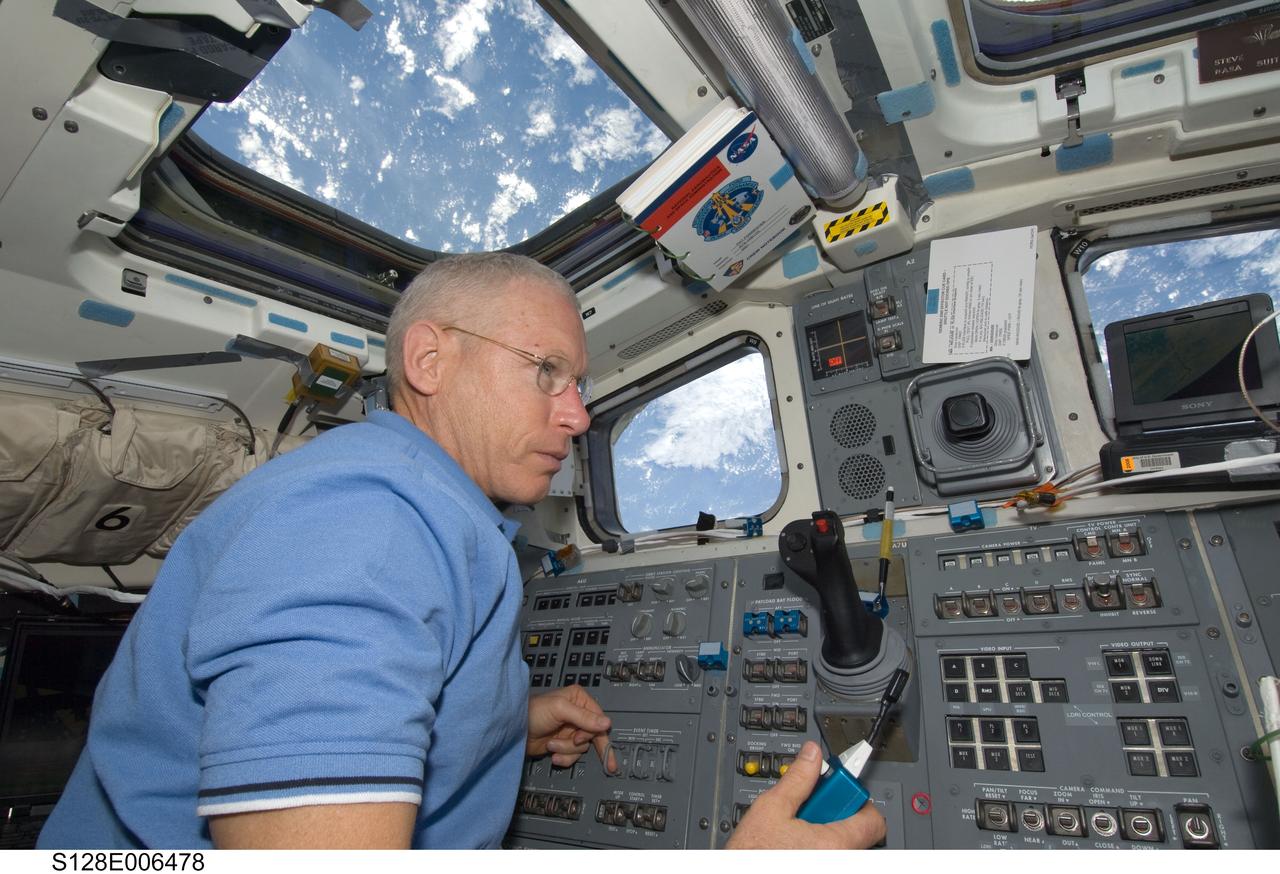 S128-E-006478 (29 Aug. 2009) --- Astronaut Patrick Forrester, STS-128 mission specialist, uses a communication system on the aft flight deck of the Earth-orbiting Space Shuttle Discovery during flight day two activities.