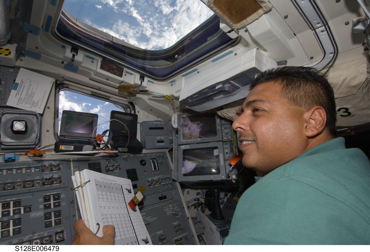 S128-E-006479 (29 Aug. 2009) --- Astronaut Jose Hernandez, STS-128 mission specialist, works on the aft flight deck of the Earth-orbiting Space Shuttle Discovery during flight day two activities.