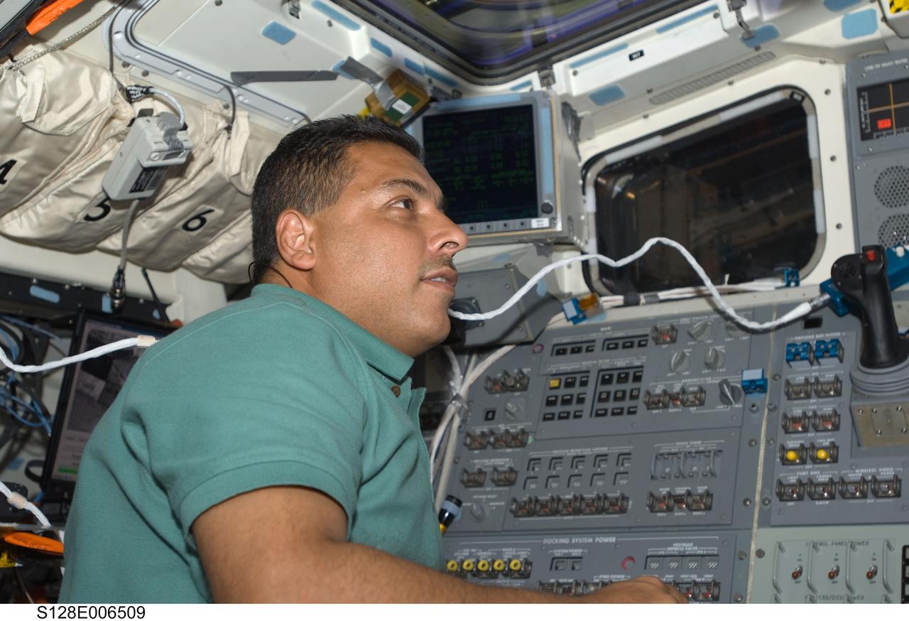S128-E-006509 (29 Aug. 2009) --- Astronaut Jose Hernandez, STS-128 mission specialist, is pictured on the aft flight deck of the Earth-orbiting Space Shuttle Discovery during flight day two activities.