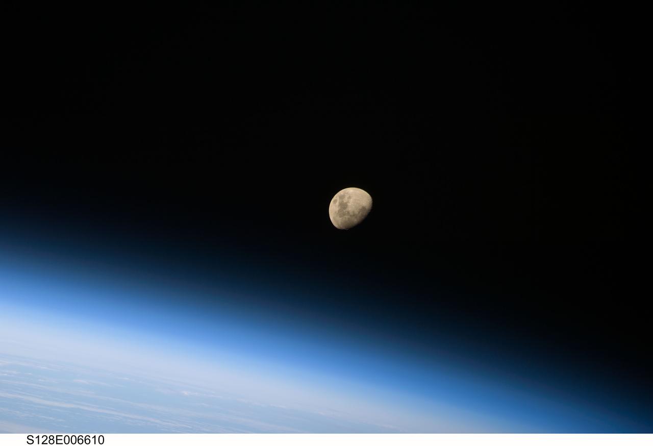 S128-E-006610 (30 Aug. 2009) --- A gibbous moon is visible above Earth's atmosphere, photographed by an STS-128 crew member on the Space Shuttle Discovery during flight day three activities.