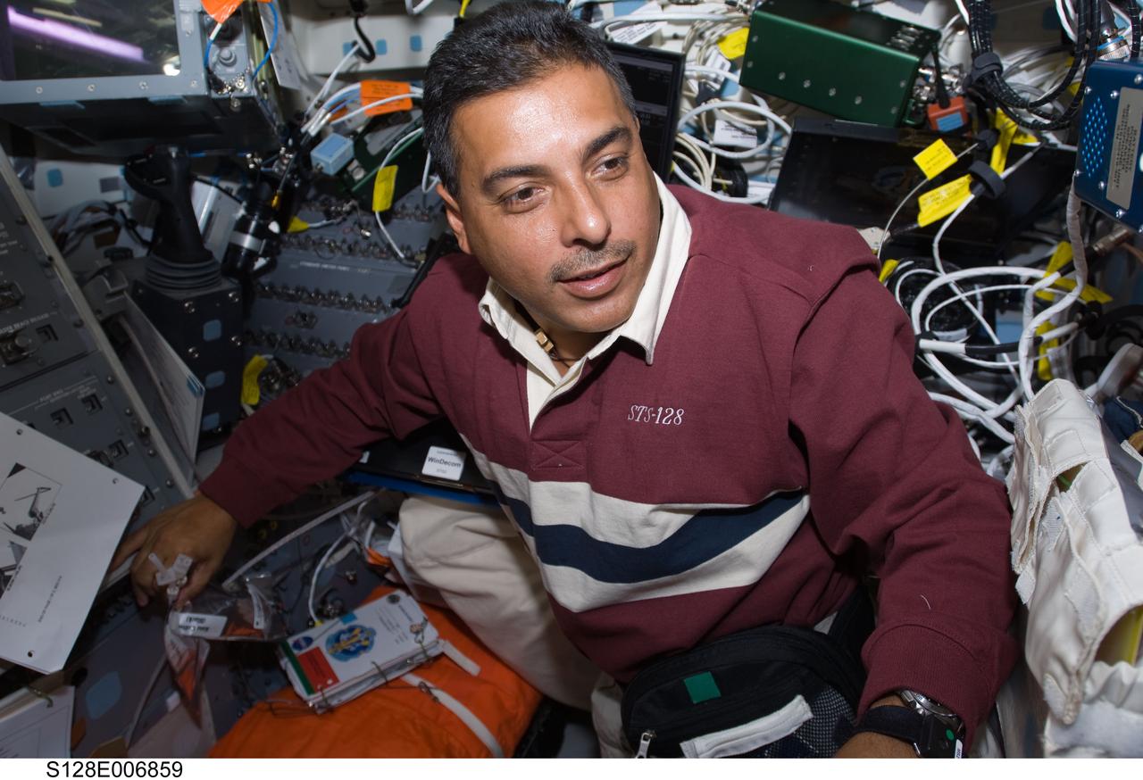 S128-E-006859 (30 Aug. 2009) --- Astronaut Jose Hernandez, STS-128 mission specialist, is pictured on the aft flight deck of Space Shuttle Discovery during flight day three activities.
