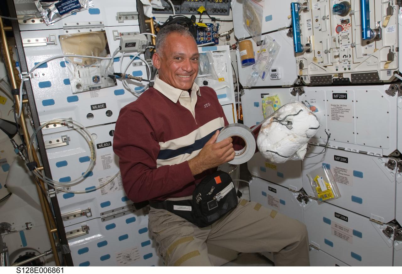 S128-E-006861 (30 Aug. 2009) --- Astronaut John “Danny” Olivas, STS-128 mission specialist, works on the middeck of Space Shuttle Discovery during flight day three activities.