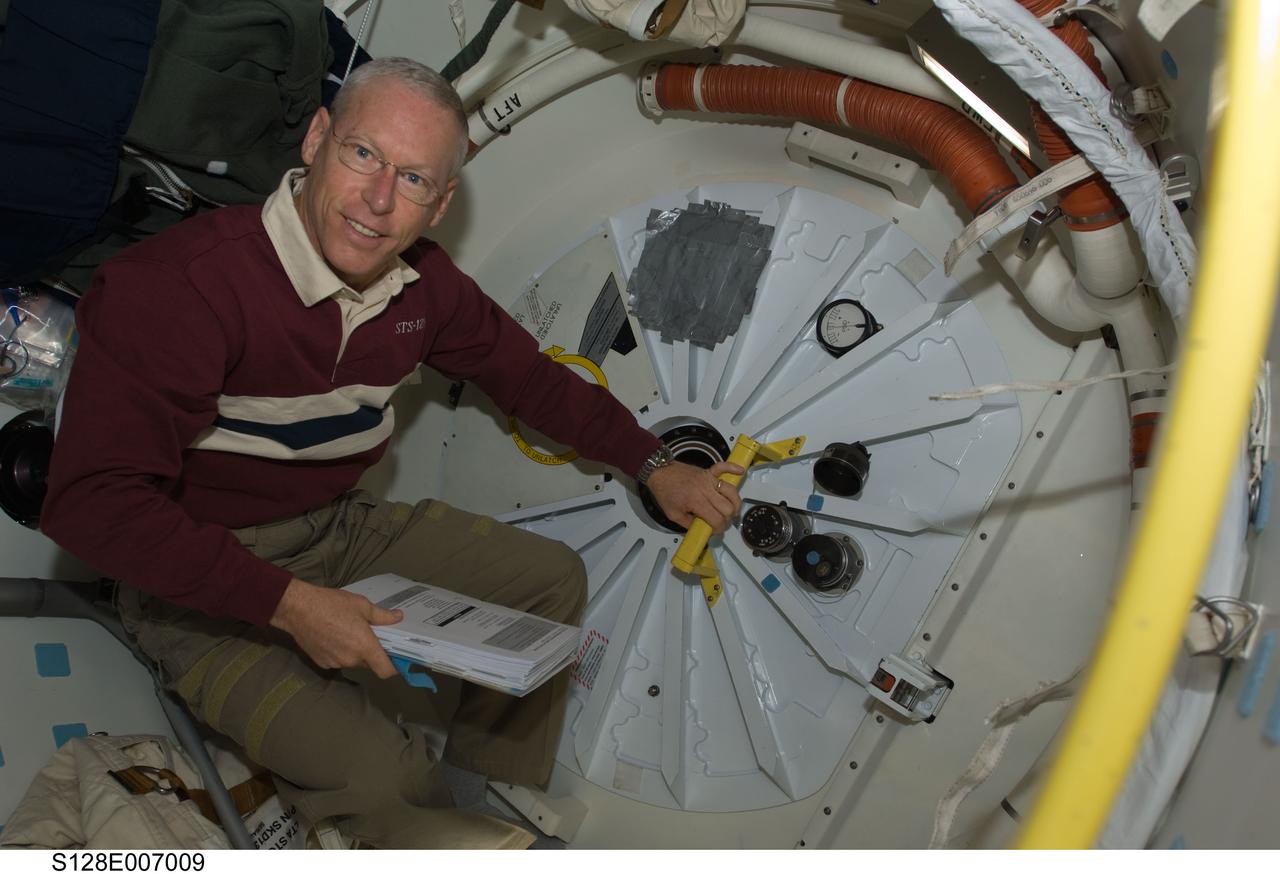 S128-E-007009 (30 Aug. 2009) --- Astronaut Patrick Forrester, STS-128 mission specialist, prepares to open the hatch that will lead the entire Space Shuttle Discovery crew into the International Space Station. The two spacecraft docked at 7:54 p.m. (CDT), and the Discovery crew entered the orbital outpost at 9:59 p.m. (CDT) on Aug. 30.