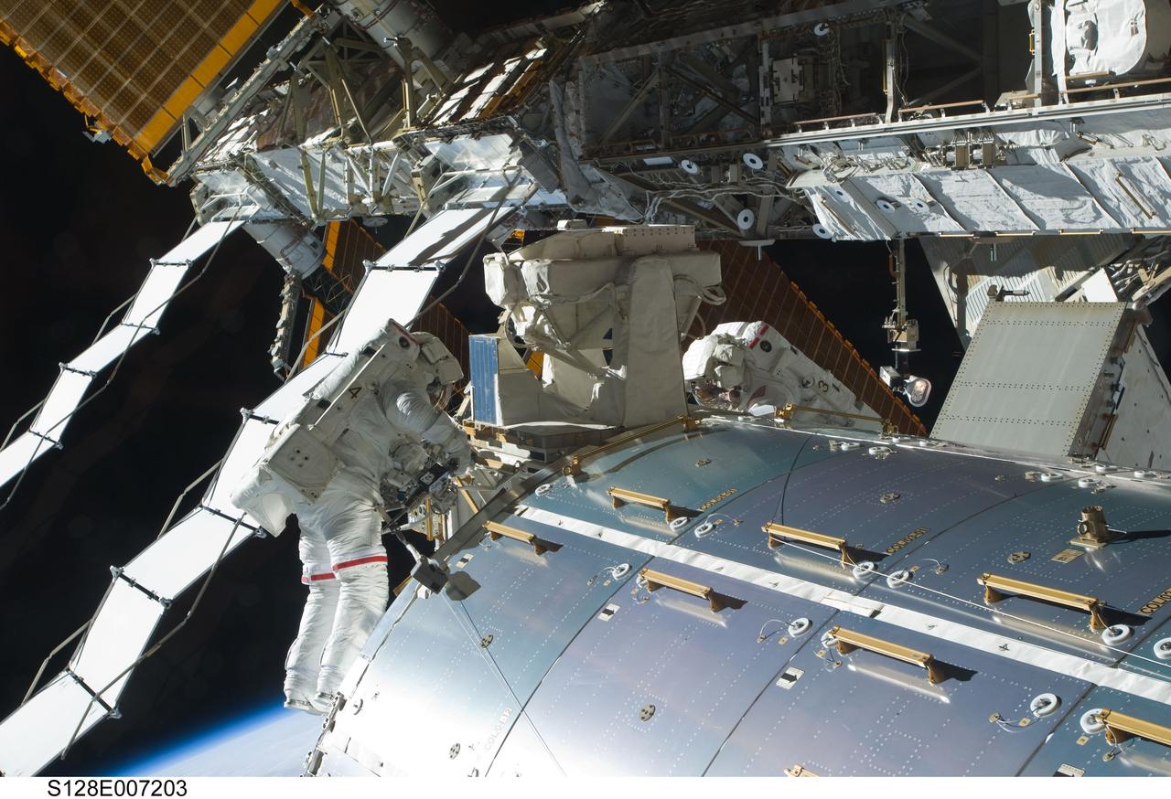 S128-E-007203 (1 Sept. 2009) --- Astronauts John “Danny” Olivas and Nicole Stott (right), both STS-128 mission specialists, participate in the mission's first session of extravehicular activity (EVA) as construction and maintenance continue on the International Space Station. During the six-hour, 35-minute spacewalk, Olivas and Stott removed an empty ammonia tank from the station’s truss and temporarily stowed it on the station’s robotic arm. Olivas and Stott also retrieved the European Technology Exposure Facility (EuTEF) and Materials International Space Station Experiment (MISSE) from the Columbus laboratory module and installed them on Discovery’s payload bay for return.