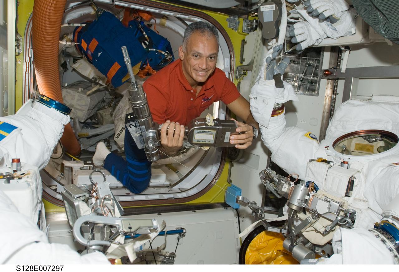 S128-E-007297 (4 Sept. 2009) ---- Astronaut John “Danny” Olivas,  STS-128 mission specialist,  checks out a power tool.   The Space Shuttle Discovery is currently docked with the International Space Station while the STS-128 astronauts  work with the Expedition 20 crewmembers aboard the orbital outpost.  In the last several days, Olivas has already participated in two days of extravehicular activity and is preparing for his third and final spacewalk on Sept. 5.